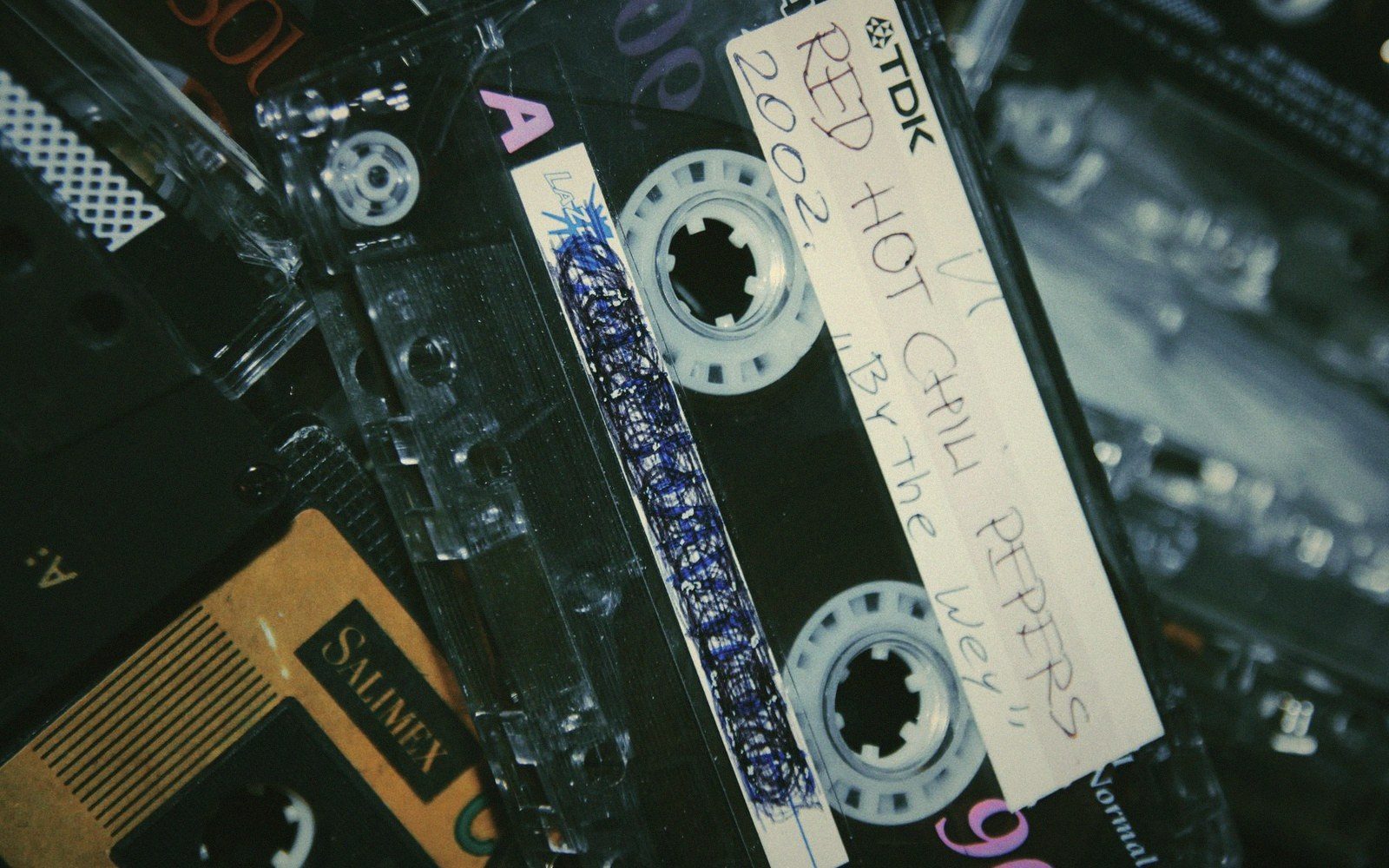 A close-up of a handwritten TDK cassette tape labeled Red Hot Chili Peppers, By the Way